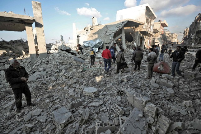 Members of the Syrian Civil Defense known as White Helmets and locals search for victims in the rubble of a building after a reported Russian airstrike on a popular market in the village of Balyun in Syria's northwestern Idlib province, on December 7, 2019. - Syrian regime and Russian air strikes killed 19 civilians today, eight of them children, in Idlib, the country's last major opposition bastion, a war monitor said. (Photo by Omar HAJ KADOUR / AFP) (Photo by OMAR HAJ KADOUR/AFP via Getty Images)