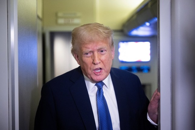 US President Donald Trump speaks to reporters aboard Air Force One while flying to Washington, DC, from Florida, on March 16, 2025, above Virginia. (Photo by Brendan Smialowski / AFP) (Photo by BRENDAN SMIALOWSKI/AFP via Getty Images)